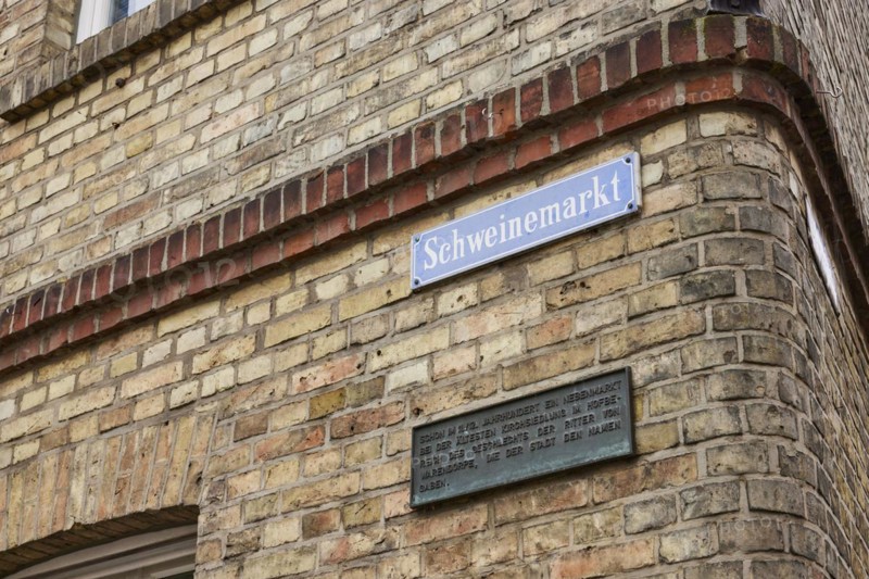 Street sign Schweinemarkt on a red brick façade in Warendorf, Warendorf district, North Rhine-Westphalia, Germany, Europe