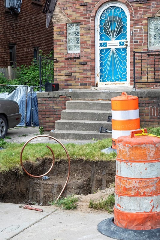 Detroit, Michigan, Workers replace old lead water service lines with copper pipes. Lead is harmful to health, especially in children. The city of Detroit estimates there are 80, 000 homes in the city with lead service lines and has begun a program to replace them all