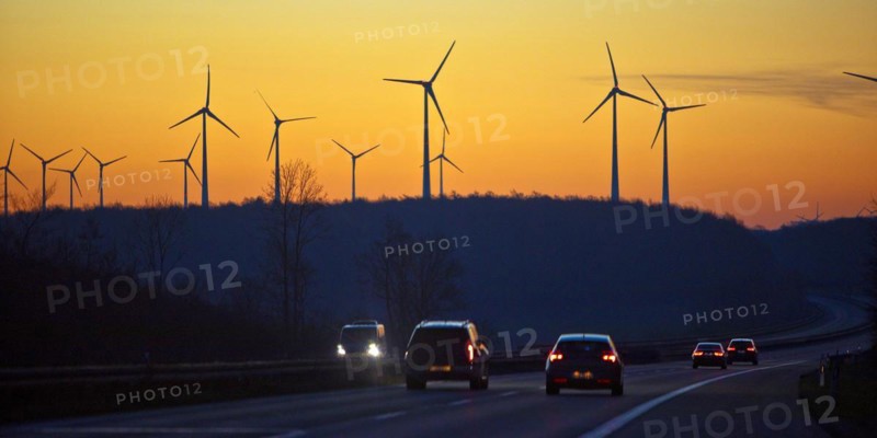 Wind turbines at sunrise with cars on the A 44 motorway, Büren, Paderborn plateau, North Rhine-Westphalia, Germany, Europe