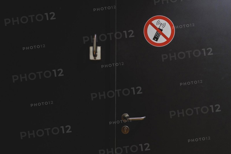 A sign banning mobile phones is stuck to a door in the German Bundestag in Berlin, 11.03.2024