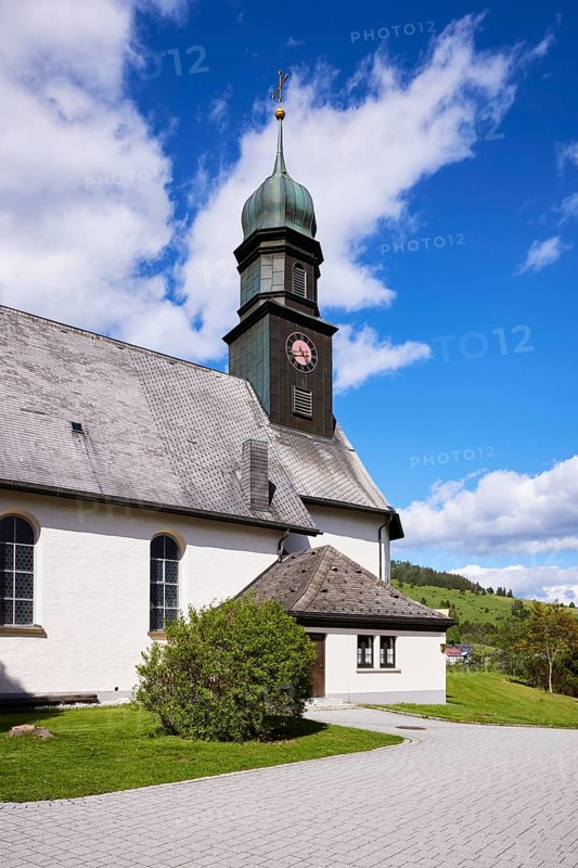 Church tower of St. Johann Church under a blue sky with cumulus clouds in the Innerlehen district, Bernau im Black Forest, Black Forest, Waldshut district, Baden-Württemberg, Germany, Europe