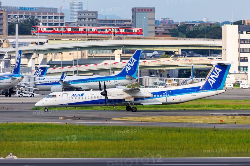 An ANA Wings Dash 8 Q400 aircraft with registration number JA842A at Itami Airport (ITM) in Osaka, Japan, Asia