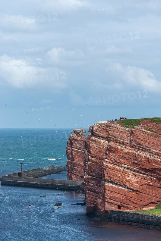 Red coloured sandstone, steep cliff coast of the offshore island of Heligoland, home of the gannets, Heligoland uplands, breakwater as wave protection, North Sea, Pinneberg district, Schleswig-Holstein, Germany, Europe
