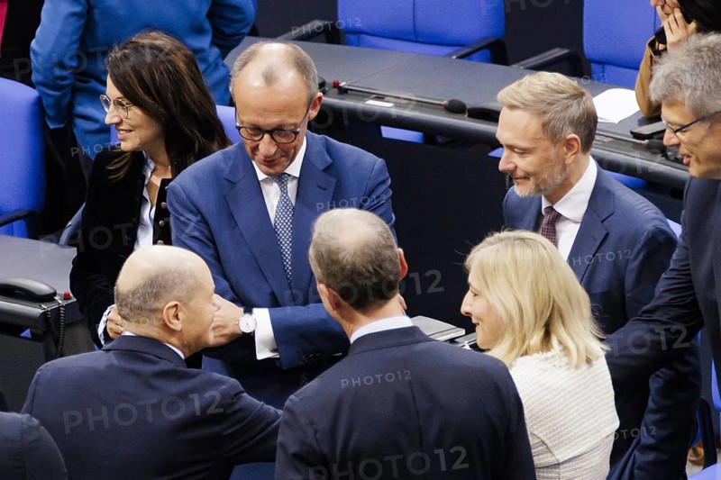 Olaf Scholz (SPD), Federal Chancellor, greets Friedrich Merz, CDU, and Christian Lindner in plenary in front of the session in the German Bundestag, Berlin, 13 November 2024