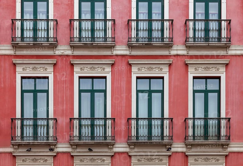 House façade with floor-to-ceiling windows and French balconies, Malaga, Andalusia, Spain, Europe