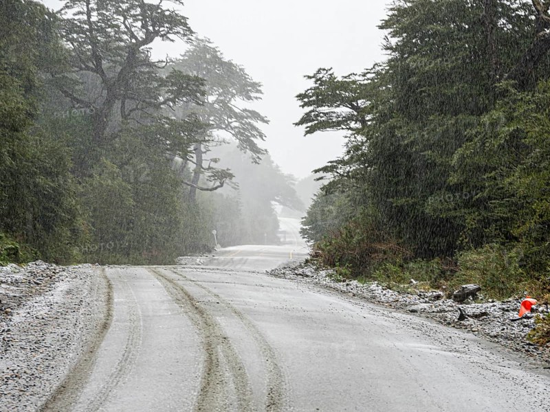 Road Carretera Austral south of village Puyuhuapi, mountain pass, gravel road, snowfall, Patagonia, Chile, South America