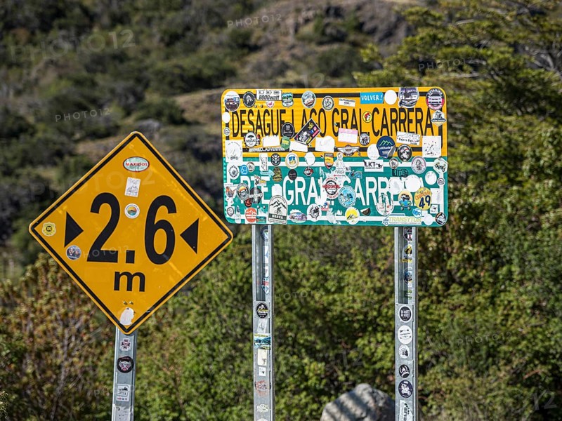 Stickers on name plate of suspension bridge Puente General Carrera, at lake Lago General Carrera, Patagonia, Chile, South America