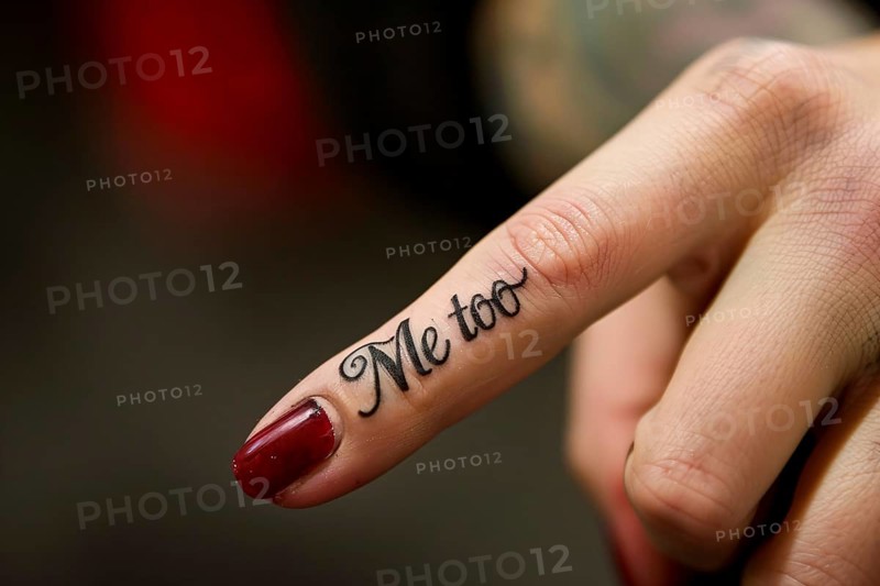 Close up of tattoo with text 'Me too' on woman's finger. Generative AI, AI generated