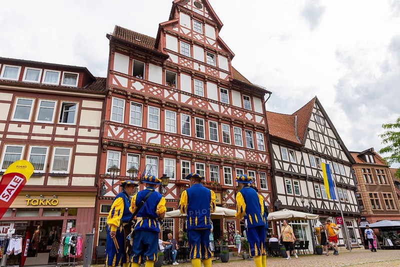 Duderstadt is a town and independent municipality in the district of Göttingen in south-east Lower Saxony. The predominantly medieval townscape is characterised by around 600 town houses of various styles - mainly half-timbered houses The town piper advertises the shooting festival. Marktstraße and historic Hotel zur Tanne, Duderstadt, Duderstadt, Lower Saxony, Germany, Europe