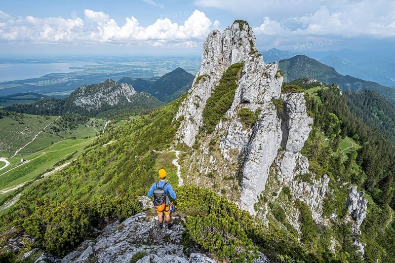 Climber on a climbing tour, on a mountain ridge, behind the summit of the Kampenwand with summit cross, alpine climbing, crossing the Kampenwand, Chiemgau, Bavaria, Germany, Europe