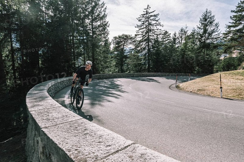 Road bike rider in spring between Lechtal and Tannheimer Tal in front of picturesque scenery of the Alps, Tyrol, Austria, Europe