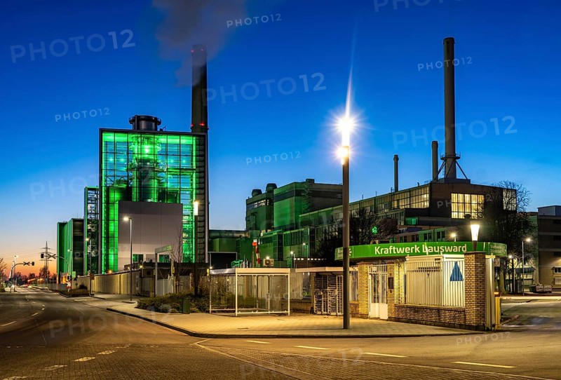 The Lausward combined heat and power plant in Düsseldorf, gas and steam turbine power plant, operated by Stadtwerke Düsseldorf and EnBW, in the harbour of Düsseldorf on the Rhine, green illuminated city window, the chimney of the Fortuna power plant unit, the power plant generates electricity, also traction current and district heating, North Rhine-Westphalia, Germany, Europe