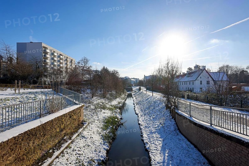 Dortmund, North Rhine-Westphalia, Germany, winter with snow in the Ruhr area, renaturalised Emscher in Dortmund-Aplerbeck at the moated castle Haus Rodenberg (right), Europe