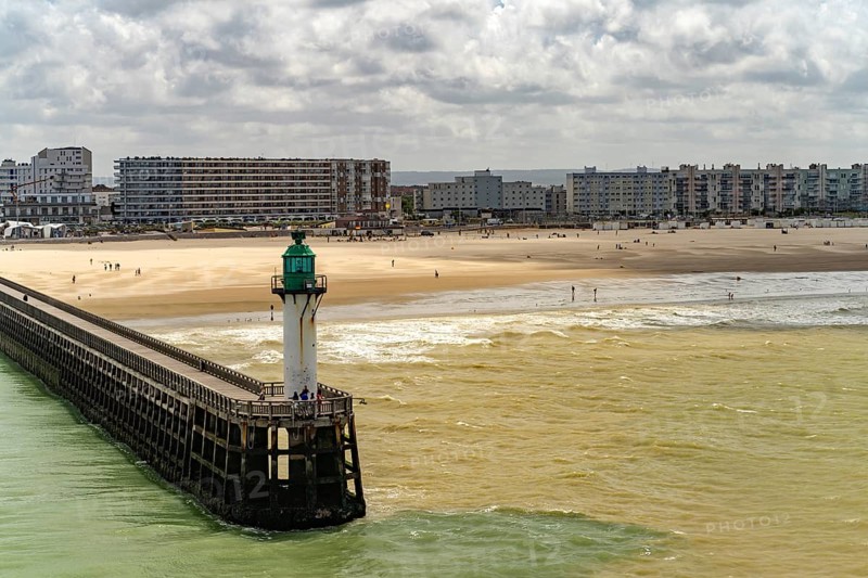 Lighthouse of the harbour entrance and beach of in Calais, France, Europe