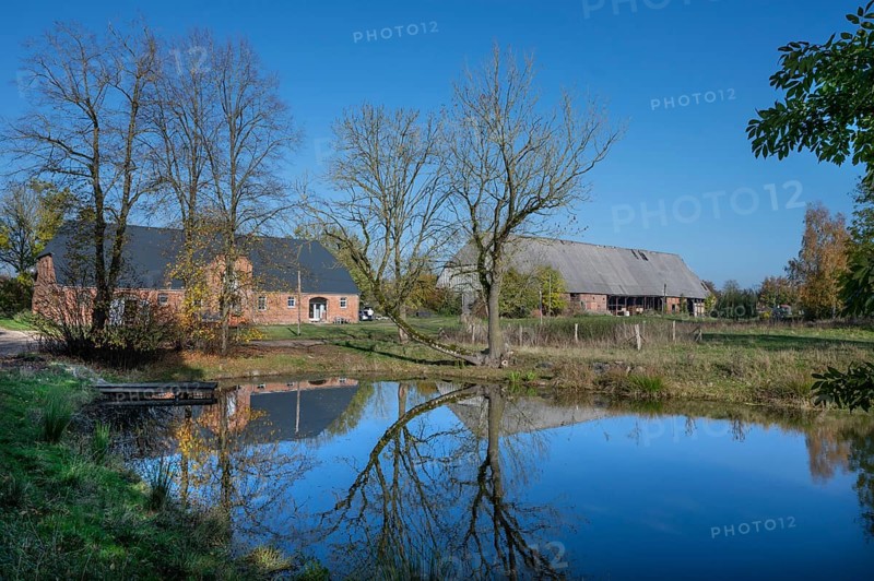 Othenstorf estate with former horse stable and large barn, built around 1900, in front the fire pond, Othenstorf near Rehna, Mecklenburg-Vorpommern, Germany, Europe