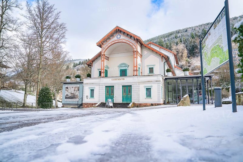 Wide angle shot of a historic theatre in the snow, surrounded by wintry nature, Königliches Kurtheater, Bad Wildbad, Black Forest, Germany, Europe