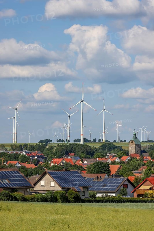 Lichtenau, North Rhine-Westphalia, Germany, wind farm in the village of Lichtenau. The wind farm is an important showcase project for climate protection in East Westphalia and for the energy town of Lichtenau. In front, residential buildings with solar panels on the roof, Europe