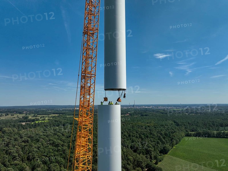 Dorsten, North Rhine-Westphalia, Germany, construction of a wind turbine, the first wind turbine of the Grosse Heide wind farm. A large mobile crane places the tower elements, the rings, on top of each other. This wind turbine will have a rated output of 5, 500 kW, Europe