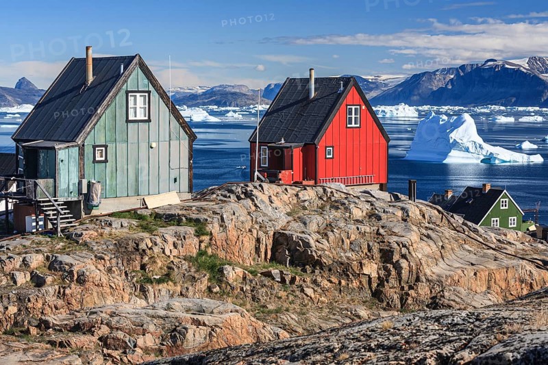 Typical Greenlandic houses in front of icebergs, Inuit settlement, summer, sunny, Uummannaq, West Greenland, Greenland, North America