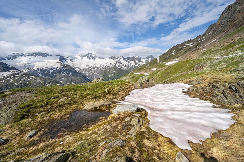 Picturesque mountain landscape with snowfield, mountain peaks with snow and glacier Schwarzensteinkees, Hornkees and Waxeggkees, Schwarzenstein summit, Hornspitzen and Großer Möseler, Berliner Höhenweg, Zillertal Alps, Tyrol, Austria, Europe