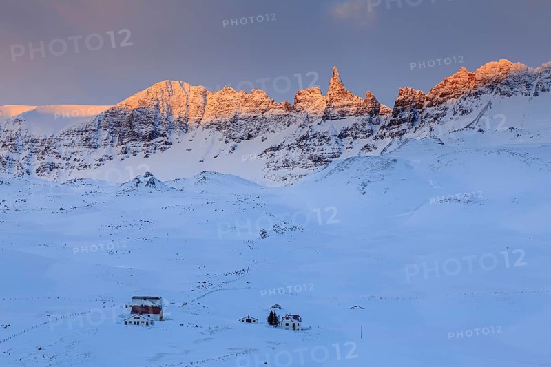 Lonely farm in front of pointed mountains in the morning light, winter, snow, Akureyri, North Iceland, Iceland, Europe