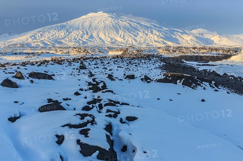 Rocks, lava field and surf at the coast, evening light, sun, snow, winter, Arnarstapi, Snaefellsjökull, Snaefellsnes, Vesturland, Iceland, Europe