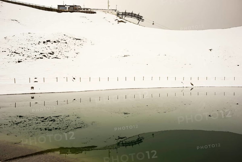 Onset of winter in May, Riezler Alpsee, an artificial lake, snow pond, feeds the snow cannons that provide the slopes of the Fellhorn and Kanzelwand cable cars with snow, Allgäu Alps, Vorarlberg, Austria, Europe