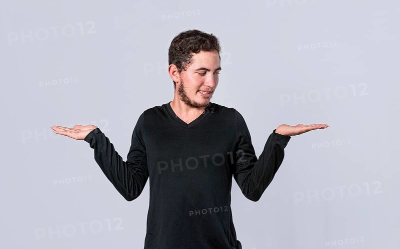 Man balancing the palms of his hands, man comparing with the palms of his hands, a guy balancing the palms of his hands