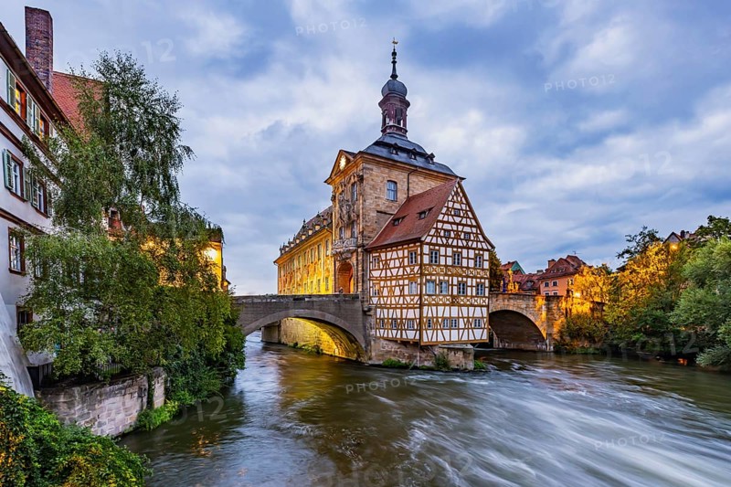Old Town Hall on an artificial island in the River Regnitz. The landmark can be reached via two arched bridges. Night shot. City view of Bamberg, Upper Franconia, Bavaria, Germany, Europe