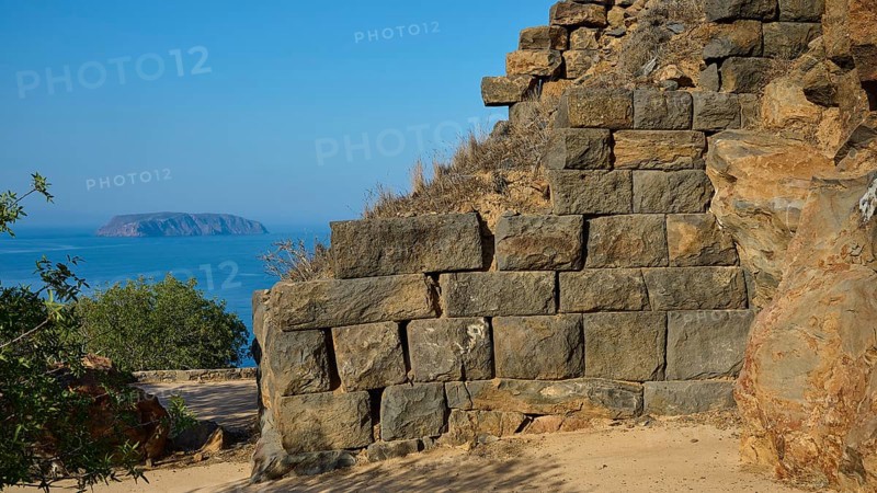 Ancient stone structures against a clear blue sky with the sea in the background, Palaiokastro, Ancient Fortress, 3rd and 4th century BC, above Mandraki, Nisyros, Dodecanese, Greek Islands, Greece, Europe