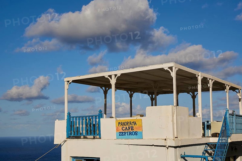 Coffee veranda with sea view and blue sky, equipped with blue railings, Colourful mountain village, Morning light, Olymbos, Karpathos, Dodecanese, Greek Islands, Greece, Europe