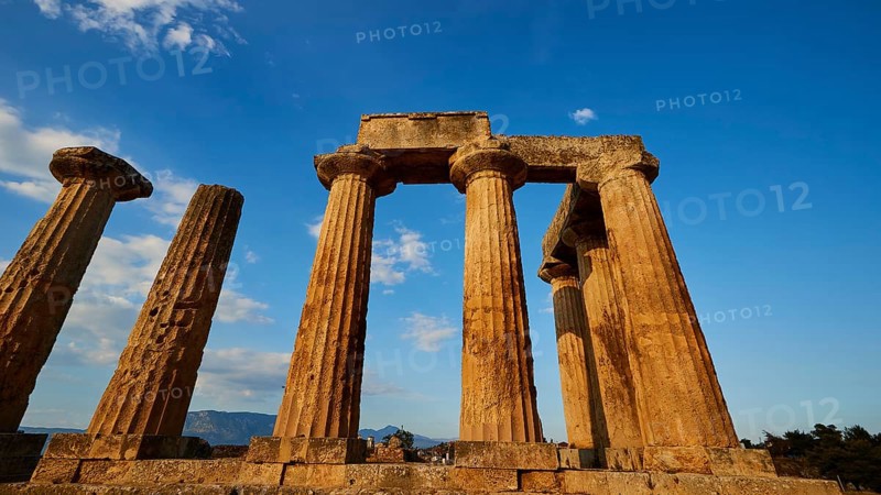 Archaic Temple of Apollo, Doric columns of a temple rise proudly under a bright blue sky, Archaeological site, Archea Korinthos, Corinth, Peloponnese, Greece, Europe