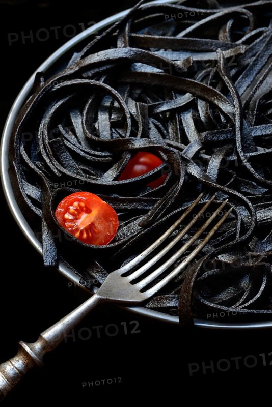 Black pasta coloured with squid ink on a plate, Taglioni al Nero di Seppia, Italy, Europe