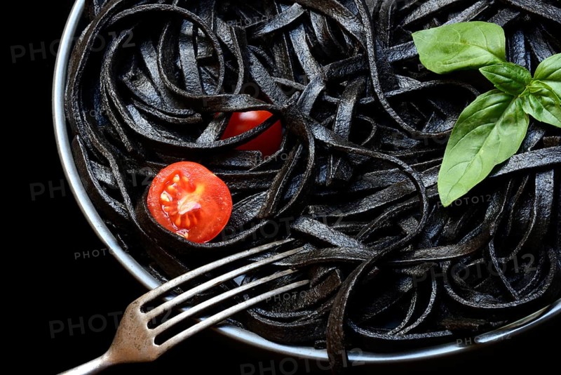 Black pasta coloured with squid ink on a plate, Taglioni al Nero di Seppia, Italy, Europe