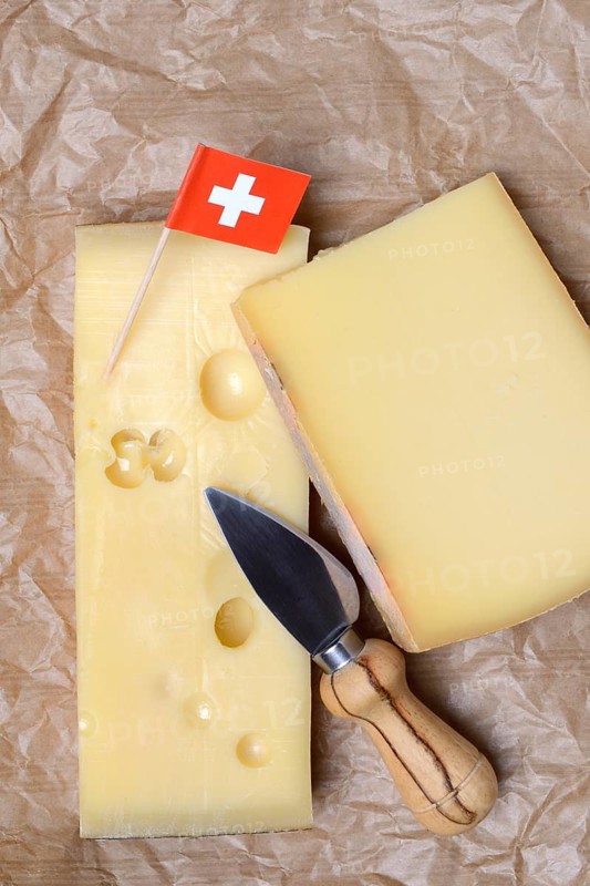 A piece of Swiss Emmental cheese and the Swiss flag
