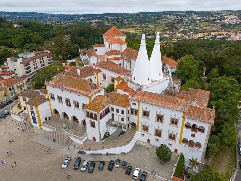 Aerial view of a large historic palace with distinctive double-cone towers and orange-red roofs, Royal Palace, Palácio Nacional de Sintra, National Palace, Sintra, Lisbon, Portugal, Europe