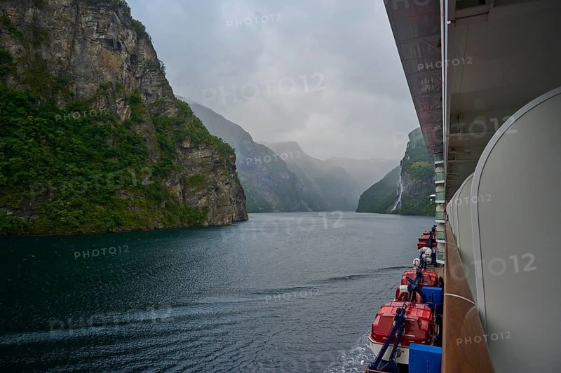 A cruise ship, my ship 6, sails through a misty fjord surrounded by green mountains and waterfalls, Geiranger, Geiranger Fjord, Stranda, Romsdal, Norway, Europe
