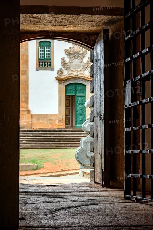 Facade of a baroque church seen from inside a historic prison from the time of the empire in the city of Mariana in Minas Gerais