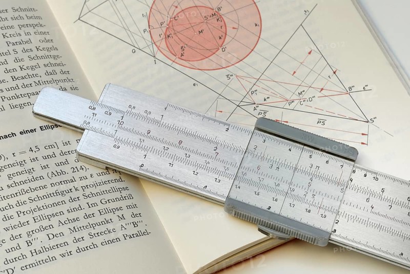 Slide rule on book, calculating aid