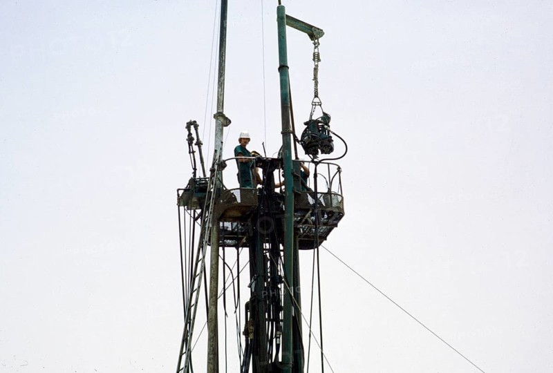 Men at work on a drilling rig in the oil exploration industry in the area of Dhahran, Saudi Arabia, Arabian Desert 1979, Asia
