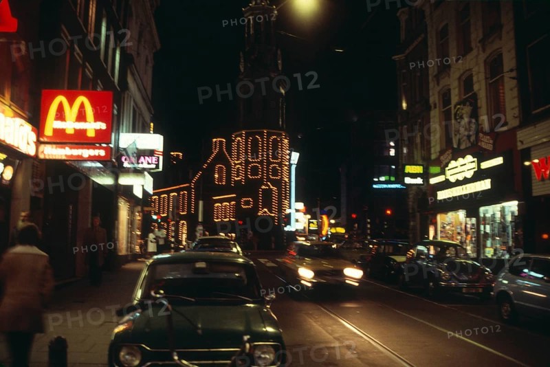 Neon lights in the city centre of Amsterdam at night, Netherlands 1970s 1980s, Macdonalds fast food restaurant