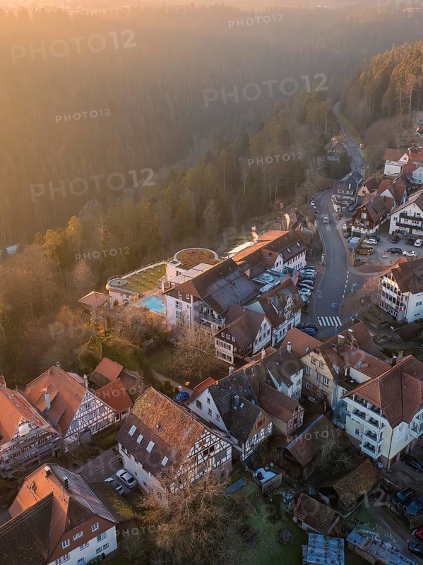 View of a village with half-timbered houses at sunrise in a hilly wooded area, Zavelstein, district of Calw, Black Forest, Germany, Europe