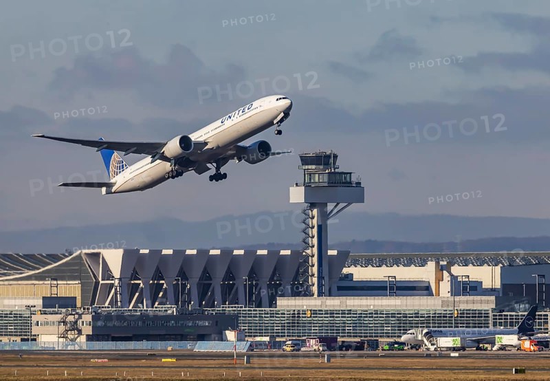 Aircraft taking off in front of the hangar and tower at Fraport Airport in Frankfurt. Aircraft registration number: N2135U, Boeing 777, United Airlines. Frankfurt am Main, Hesse, Germany, Europe