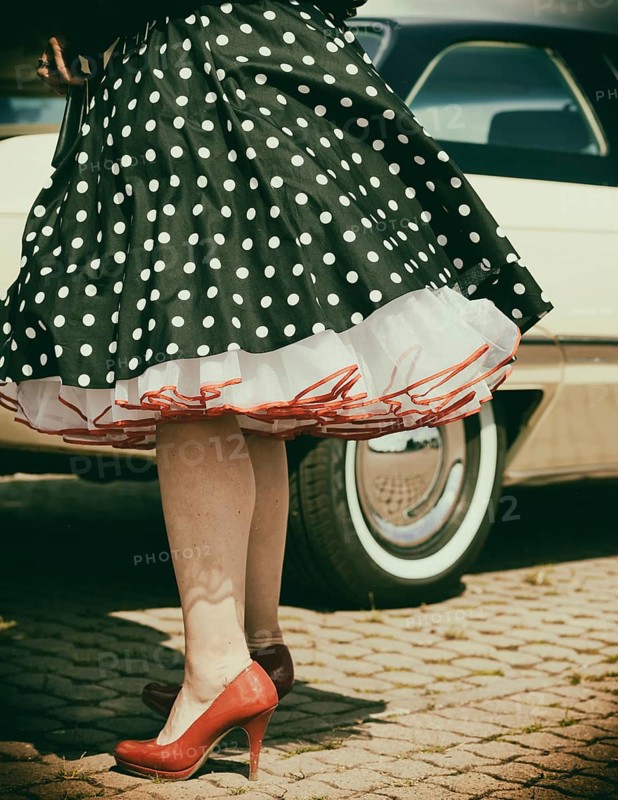 Vintage American road cruiser Buick with woman and petticoat