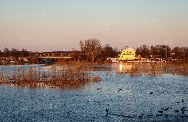 Wesel, North Rhine-Westphalia, Germany - Sunny winter landscape in the Ruhr area, ice and snow on the river Lippe, Lippe meadows shortly in front of the mouth into the Rhine, on the right the Lippeschlösschen