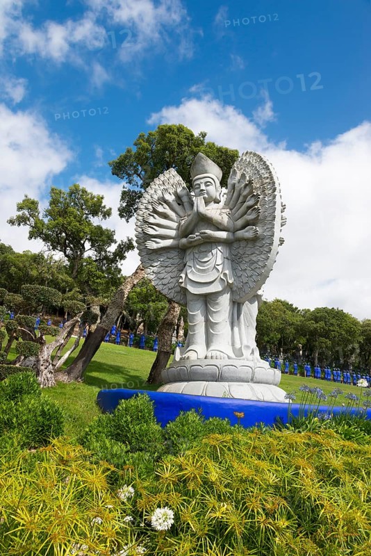Statues of Buddha in a manicured garden with trees and a blue sky, Bacalhôa, Bacalhoa Buddha Eden, Quinta dos Loridos, largest oriental garden in Europe, Bombarral, Oeste, Centro, Portugal, Europe