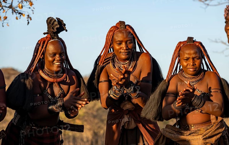 Traditional Himba woman clapping, music and dance, portraits, in the evening light, near Opuwo, Kaokoveld, Kunene, Namibia, Africa