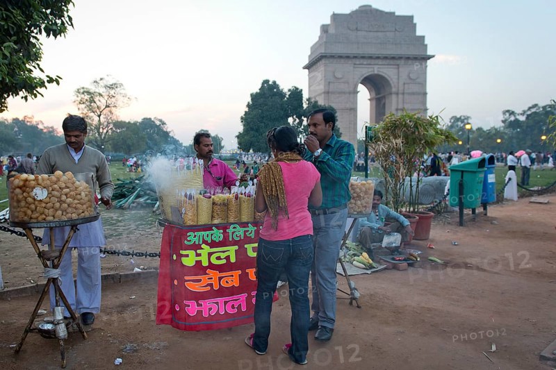 Men standing at a food stall selling snacks in front of the Amar Jawan Jyoti, India Gate, All India War Memorial by Sir Edwin Landseer Lutyens, New Delhi, Delhi, India, Asia