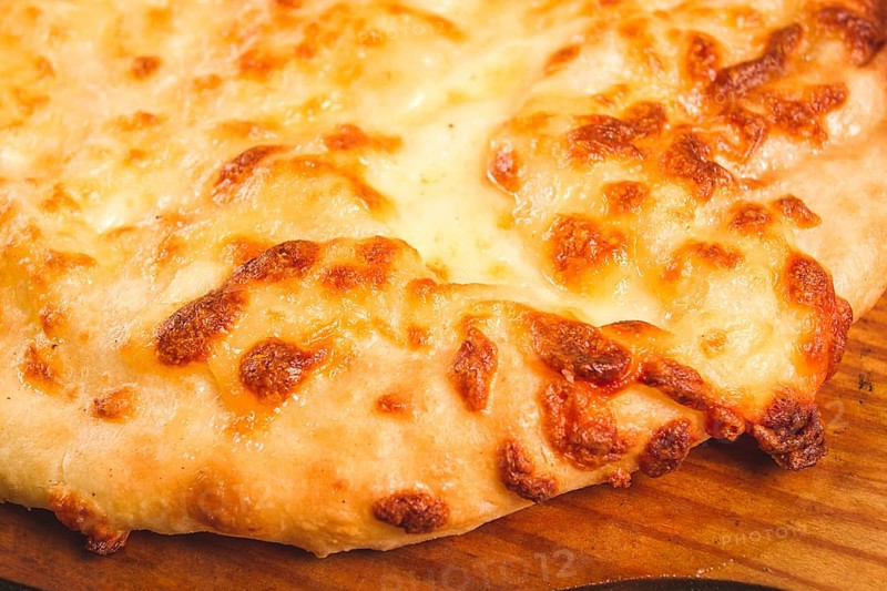 Imereti khachapuri, Traditional Georgian dish, flatbread with cheese, top view, no people, rustic
