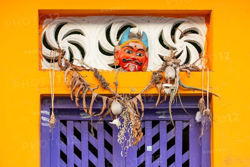 Purple-coloured front door, yellow wall, house entrance with demon mask, Rameswaram or Rameshwaram, Pamban Island, Tamil Nadu, India, Asia